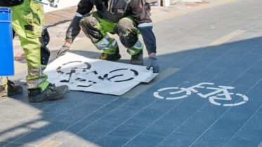 Workers,In,Paint-stained,Overalls,Renew,The,Marking,Of,The,Bicycle